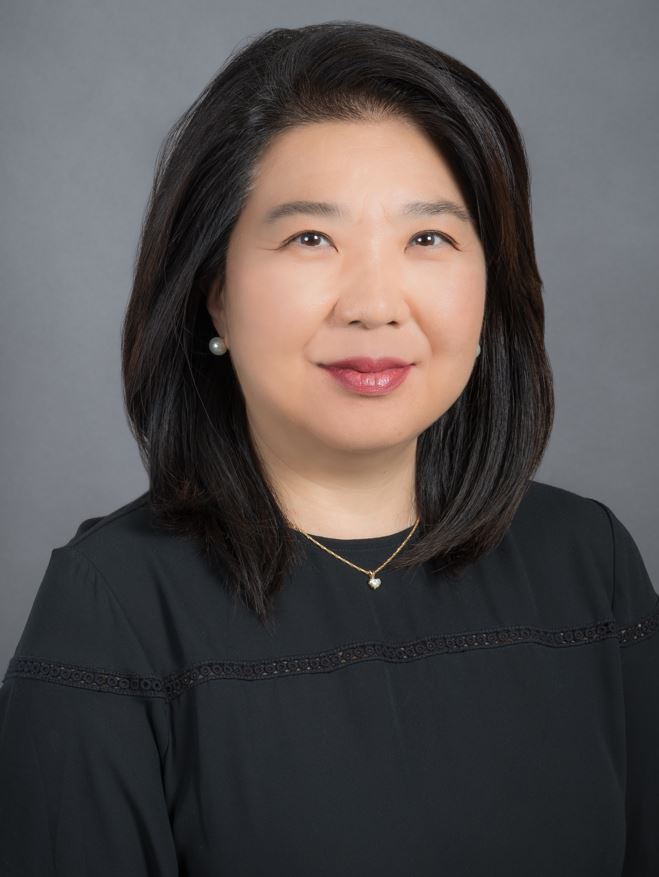Dr. Esther Choi is smiling while looking right at the camera. 