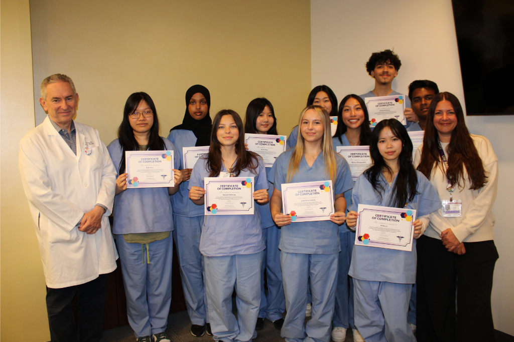 Participants from a previous HS Immersion Week pose with their certificates and co-directors Dr. Hubert Vesselle and Arin Winsor.